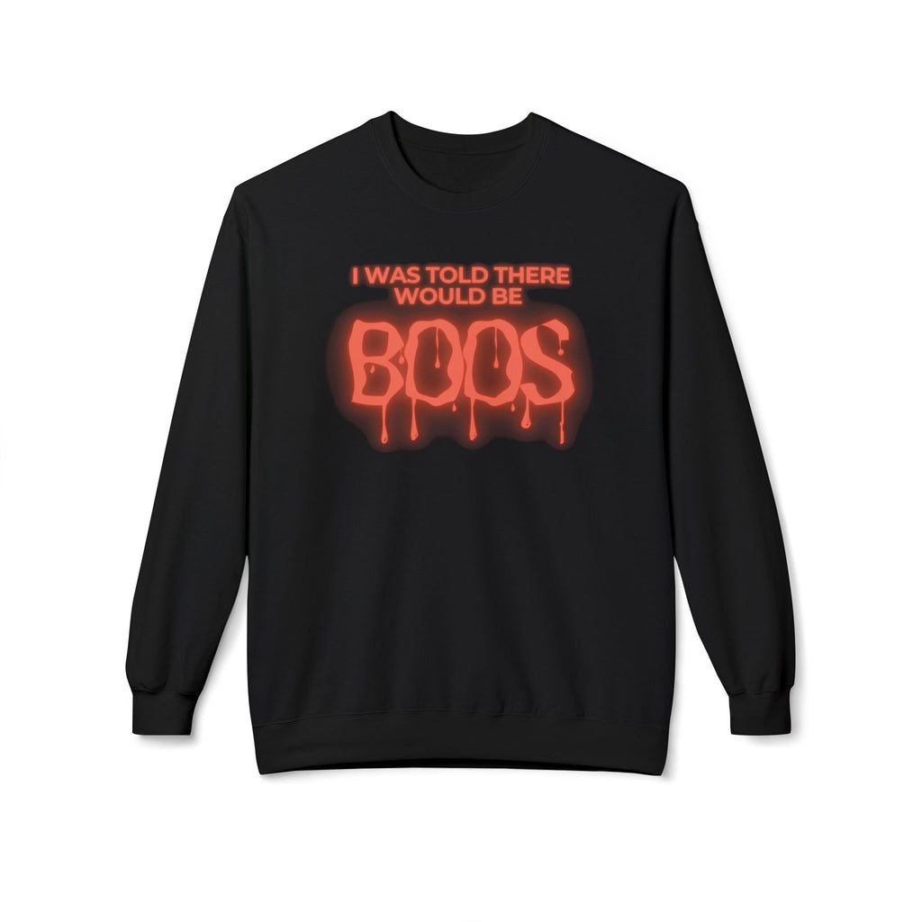 A black crewneck sweatshirt featuring a red and orange graphic on the chest that reads 'I WAS TOLD THERE WOULD BE BOOS' in dripping, glowing lettering, displayed against a plain white background.